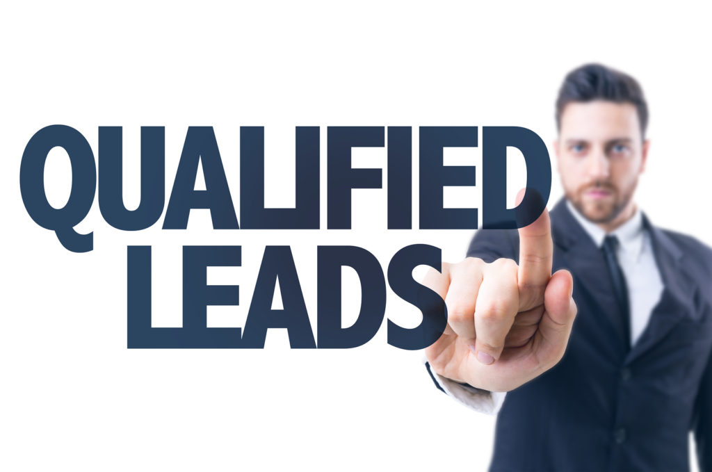 Business man pointing the text: Qualified Leads